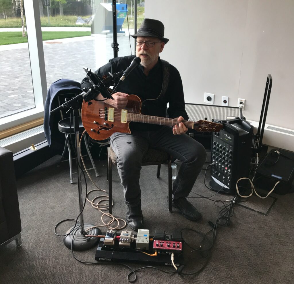 Neil D Speers playing music for a medical convention wine and cheese event in Banff, AB